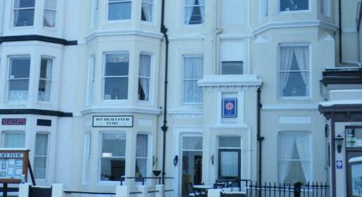 The cream Victorian facade of The Stuart House Hotel with its sign