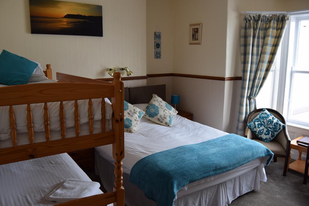 A family room with a double bed and bunk beds